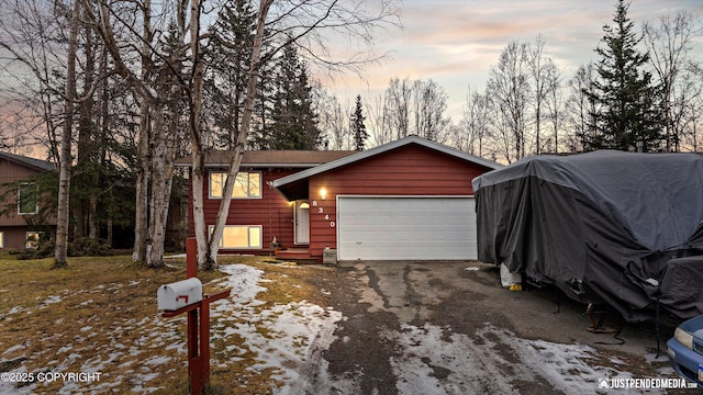 view of front of home featuring aphalt driveway and an attached garage