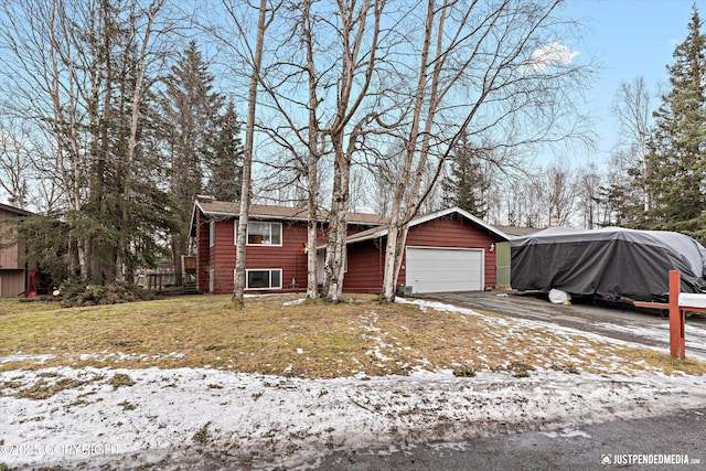 view of front of house with a garage and a front lawn