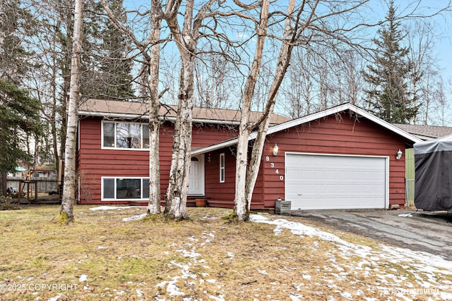 view of front of property featuring a garage and aphalt driveway