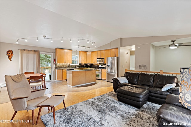 living room with vaulted ceiling, light wood-style flooring, and a ceiling fan