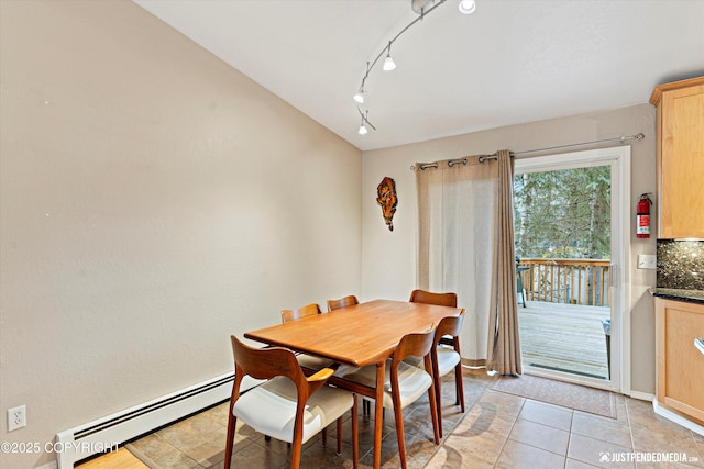 dining space featuring light tile patterned floors and a baseboard radiator