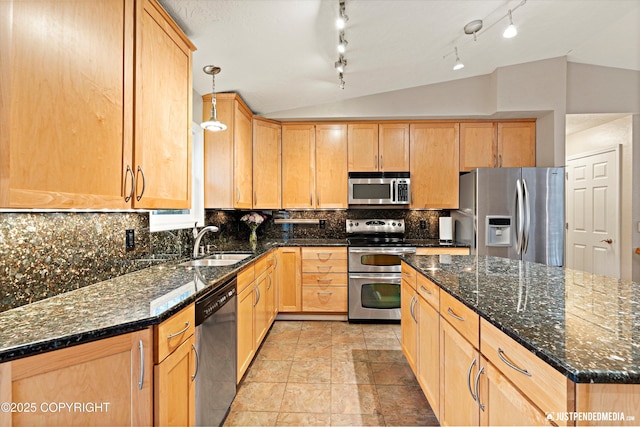 kitchen with decorative backsplash, vaulted ceiling, stainless steel appliances, light brown cabinets, and a sink