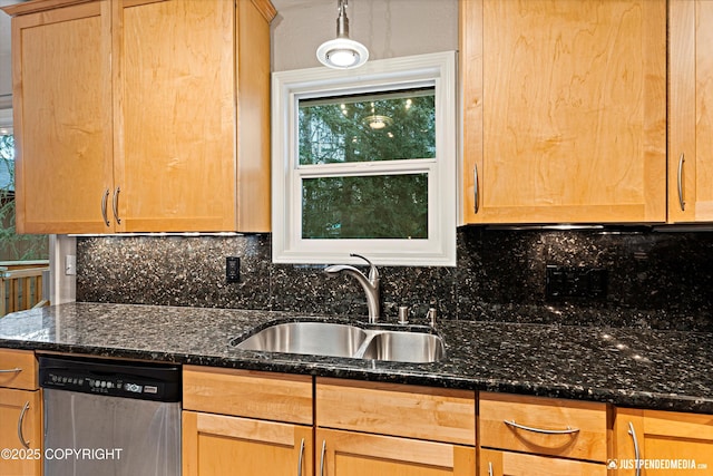 kitchen featuring tasteful backsplash, dark stone counters, stainless steel dishwasher, light brown cabinets, and a sink