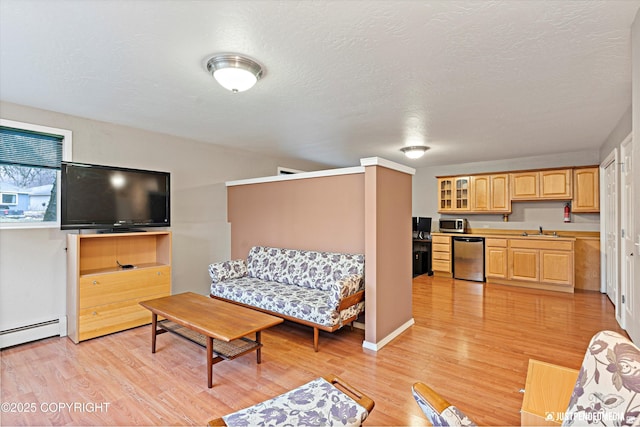 living area with a textured ceiling and light wood-type flooring