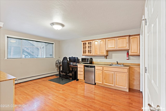 home office featuring light wood-type flooring, a baseboard radiator, a sink, and a textured ceiling