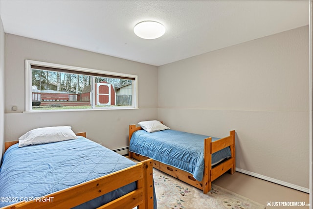 bedroom with a baseboard radiator and baseboards