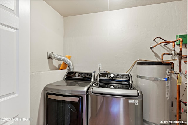 laundry room featuring water heater and washer and clothes dryer