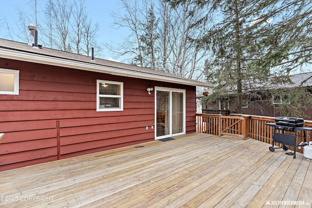 wooden terrace with a grill