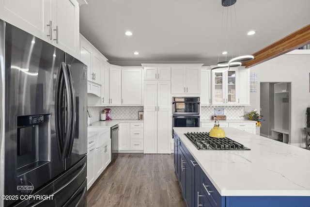 kitchen featuring appliances with stainless steel finishes, white cabinetry, and blue cabinetry