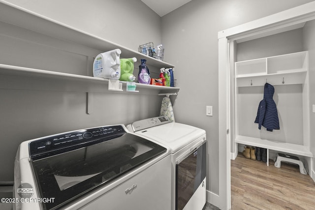 laundry room featuring laundry area, independent washer and dryer, and wood finished floors