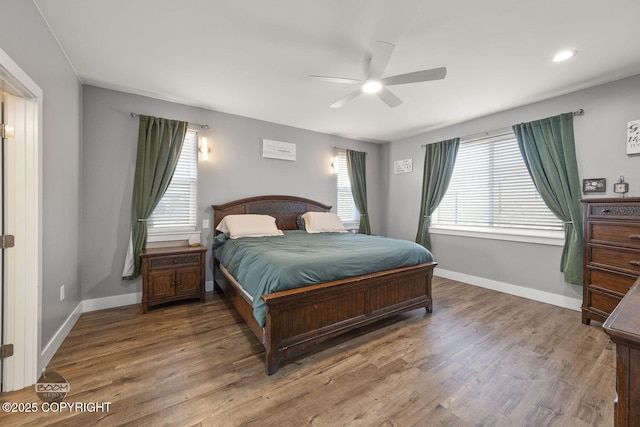 bedroom featuring ceiling fan, baseboards, and wood finished floors