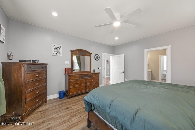 bedroom with baseboards, ceiling fan, ensuite bathroom, light wood-type flooring, and recessed lighting