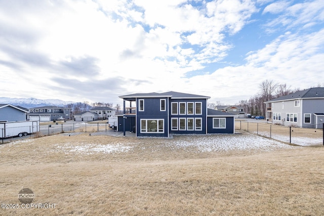 exterior space featuring a residential view, a fenced backyard, and a yard