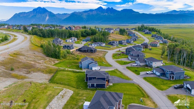 drone / aerial view featuring a residential view and a mountain view