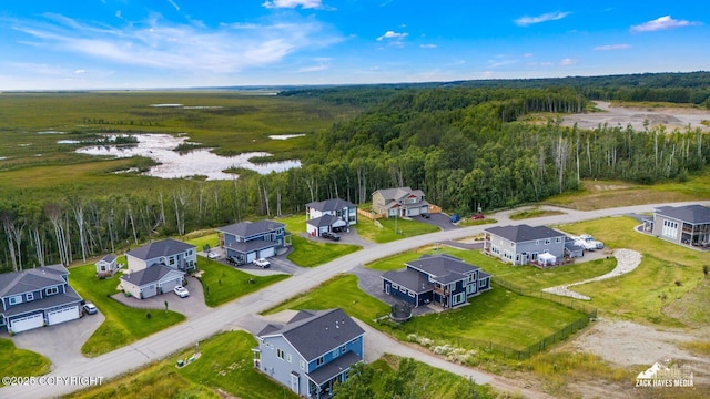 birds eye view of property with a residential view and a wooded view