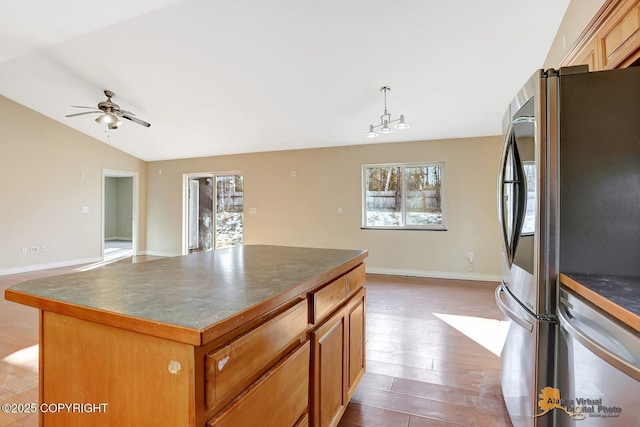 kitchen with dark countertops, a center island, lofted ceiling, smart refrigerator, and wood finished floors