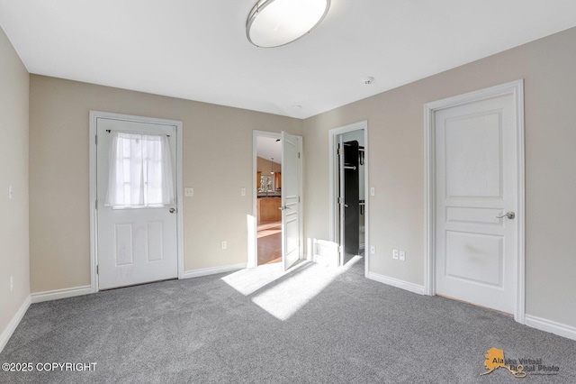 unfurnished bedroom featuring baseboards and carpet floors