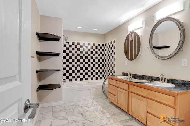 bathroom featuring a sink, marble finish floor, recessed lighting, and double vanity