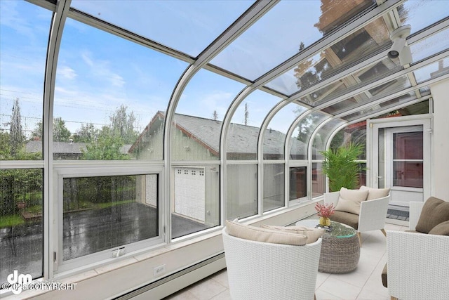 sunroom / solarium featuring a baseboard radiator and lofted ceiling