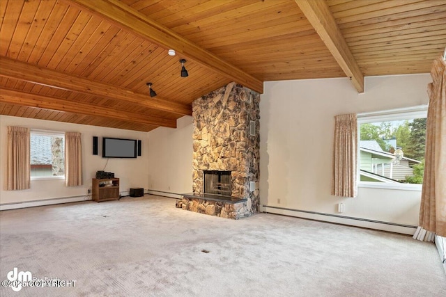 unfurnished living room with a stone fireplace, lofted ceiling with beams, a healthy amount of sunlight, and baseboard heating