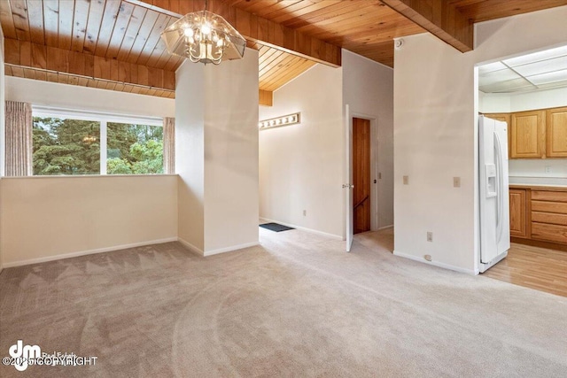 empty room featuring baseboards, an inviting chandelier, beam ceiling, wood ceiling, and light colored carpet