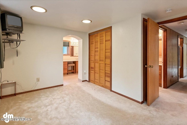 interior space featuring arched walkways and baseboards