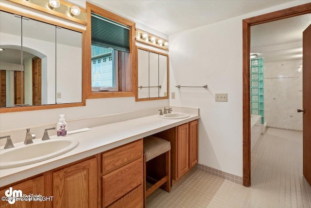 bathroom featuring double vanity, plenty of natural light, and a sink