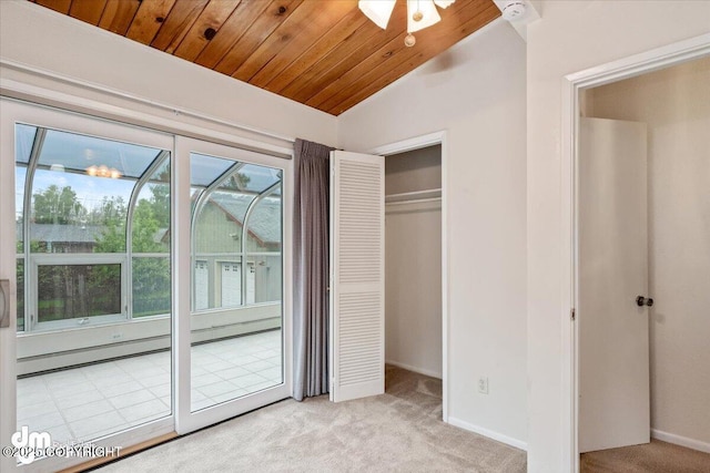 unfurnished bedroom featuring a closet, carpet, wooden ceiling, baseboards, and vaulted ceiling