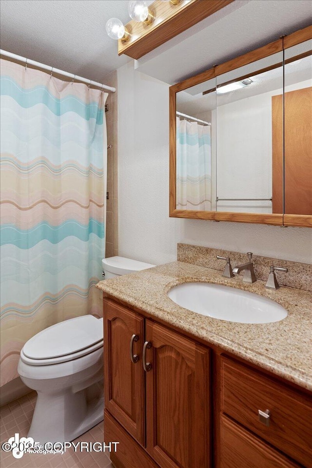 bathroom with tile patterned floors, a shower with shower curtain, toilet, and vanity