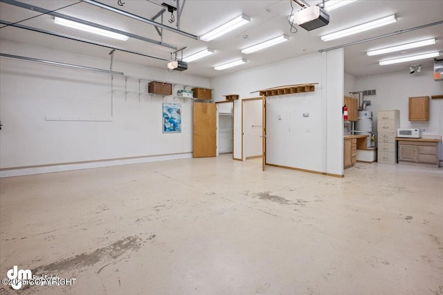 garage with secured water heater and a garage door opener