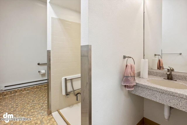 bathroom with a walk in shower, a baseboard radiator, and a sink