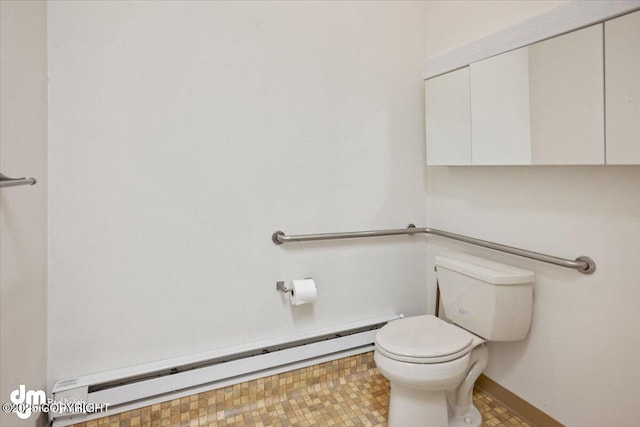 bathroom featuring baseboard heating and toilet