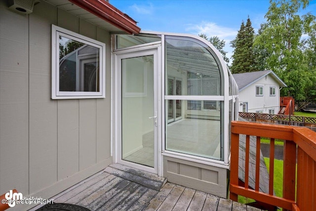 wooden deck with a sunroom