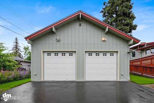 detached garage featuring fence