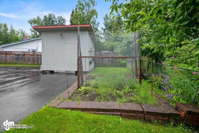 view of shed with fence