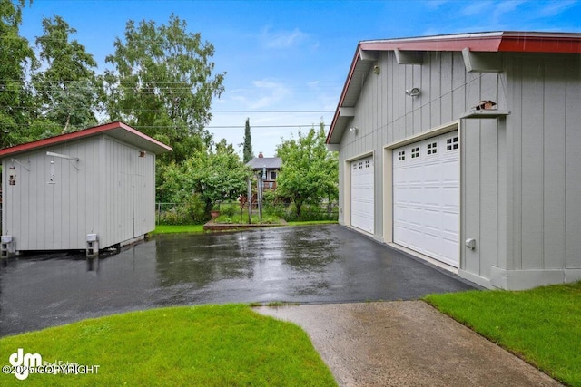 garage featuring aphalt driveway