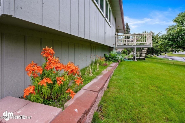 view of yard with a wooden deck and stairs