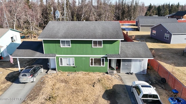 408 Haller St, Kenai, AK 99611 - view of front of property with roof with shingles, a carport, a view of trees, and concrete driveway