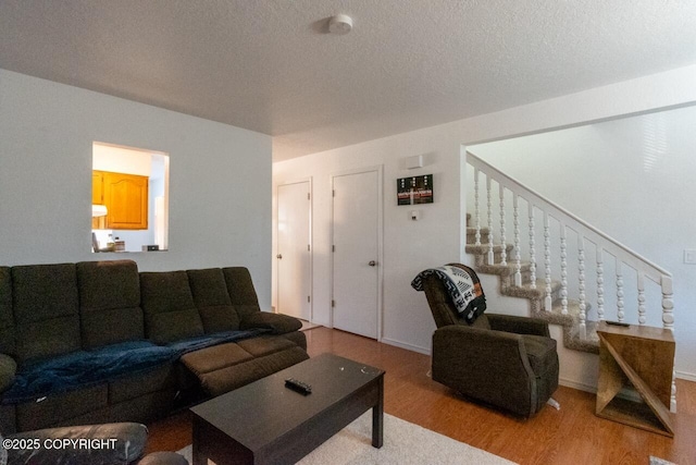 408 Haller St, Kenai, AK 99611 - living room with wood finished floors, stairway, and a textured ceiling