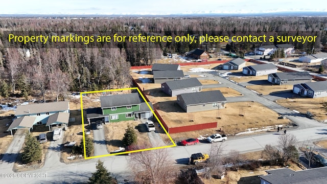 408 Haller St, Kenai, AK 99611 - aerial perspective of suburban area with a heavily wooded area and property parcel outlined