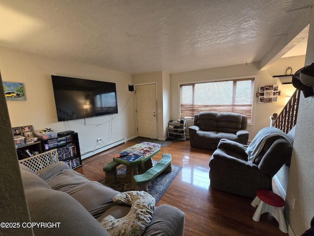 408 Haller St, Kenai, AK 99611 - living area featuring a baseboard radiator, wood finished floors, and a textured ceiling