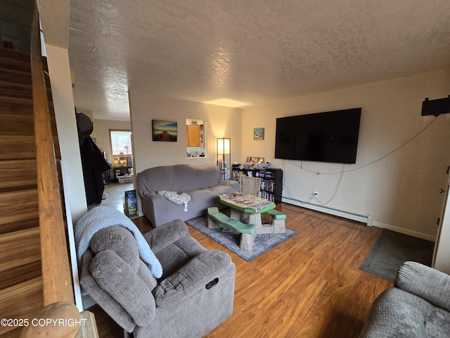 408 Haller St, Kenai, AK 99611 - living area with a baseboard heating unit, a textured ceiling, wood finished floors, stairs, and baseboards