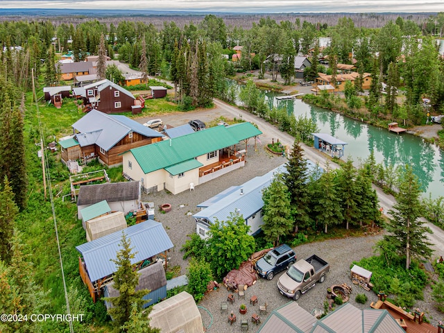 drone / aerial view featuring a water view and a residential view