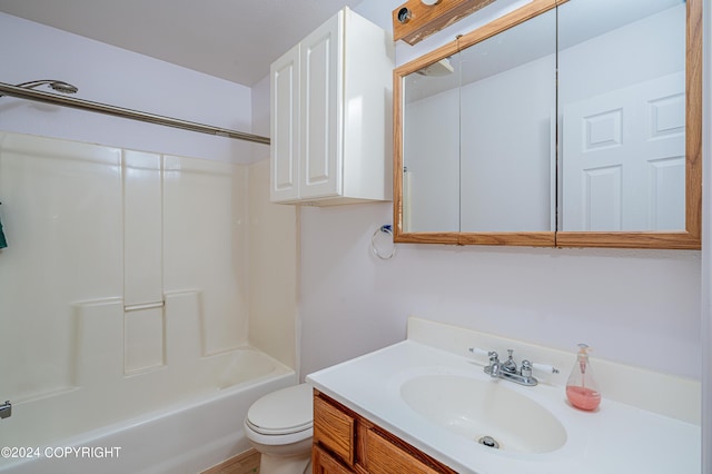 bathroom featuring washtub / shower combination, vanity, and toilet