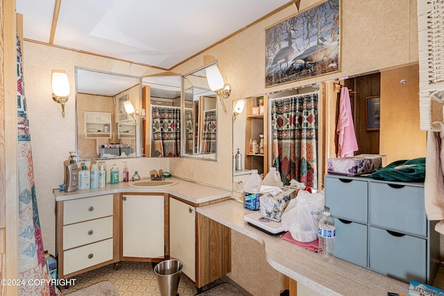 bathroom featuring vanity, crown molding, and tile patterned floors