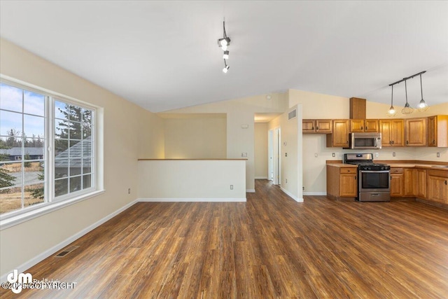 kitchen featuring dark wood-style floors, lofted ceiling, visible vents, appliances with stainless steel finishes, and brown cabinetry