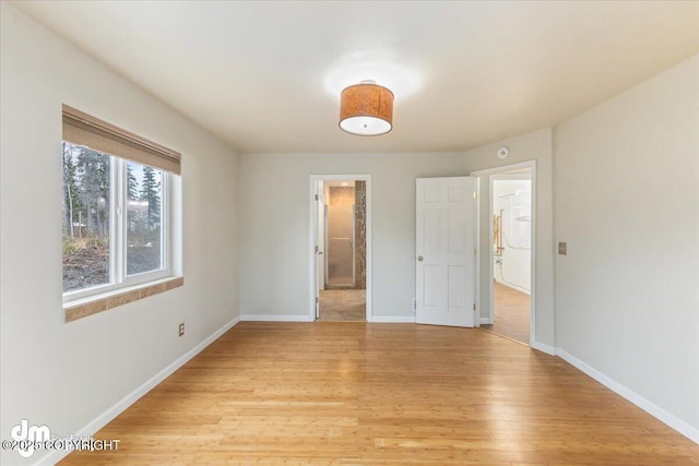 unfurnished bedroom featuring baseboards and light wood finished floors