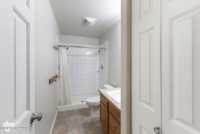 bathroom with toilet, a shower stall, and vanity