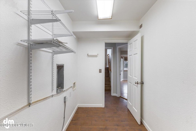 interior space with baseboards and wood finished floors