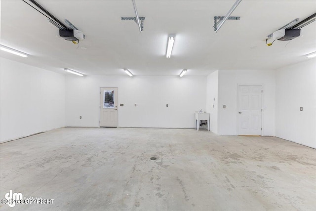 garage featuring a sink and a garage door opener